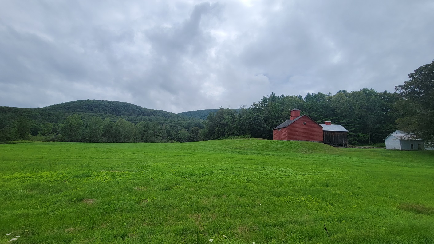 A farm in Tyringham with red farmyard buildings